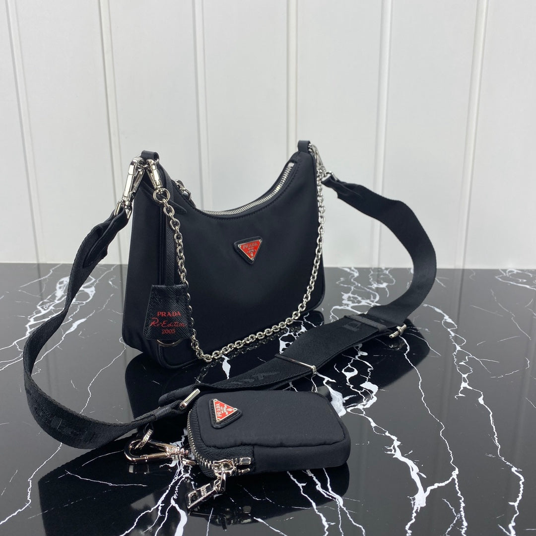 PRADA HOBO 22 BAG IN BLACK RE-NYLON WITH RED LOGO