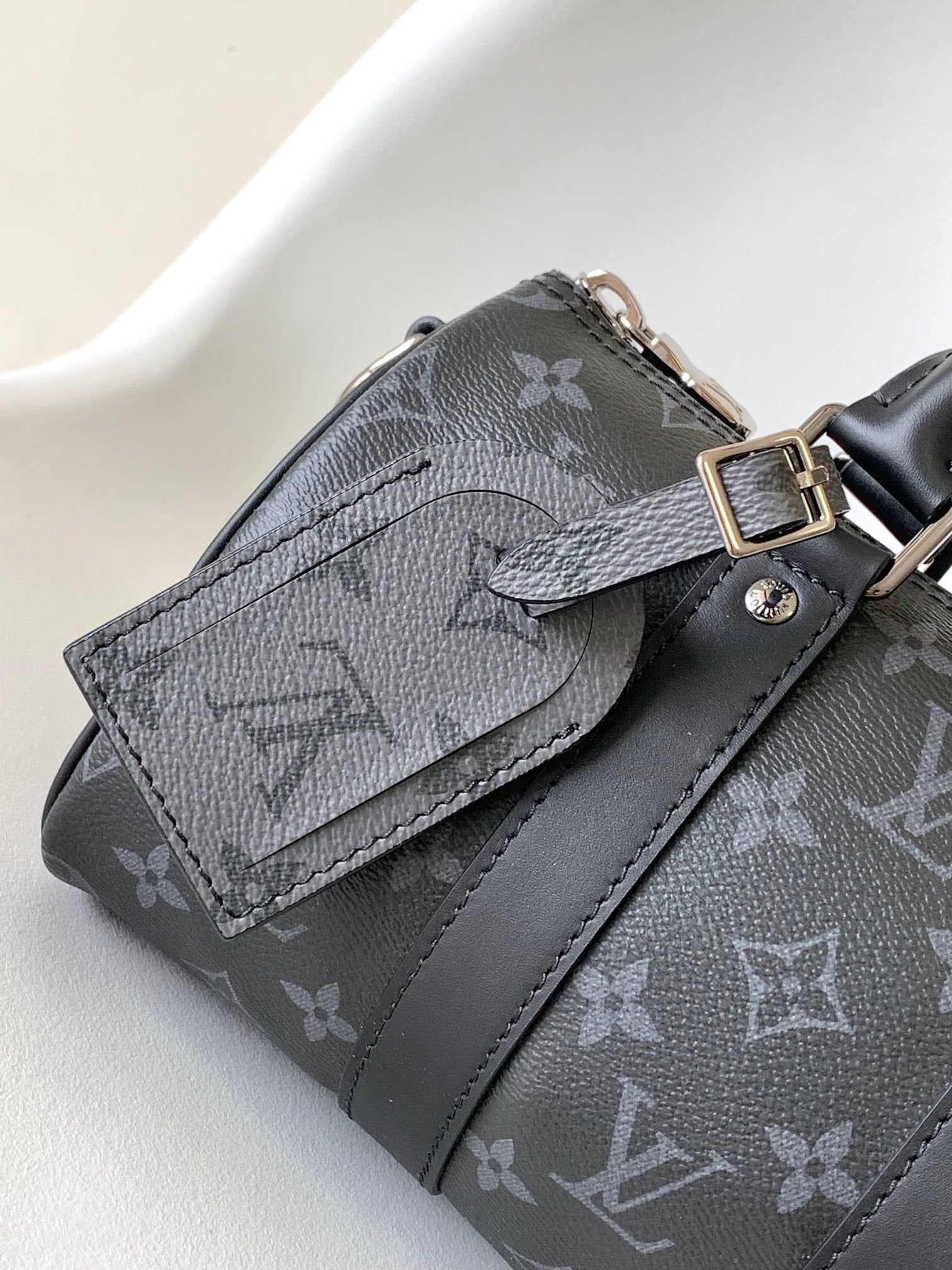 LOUIS VUITTON KEEPALL BANDOULIÈRE 25 IN BLACK MONOGRAM HERITAGE CANVAS