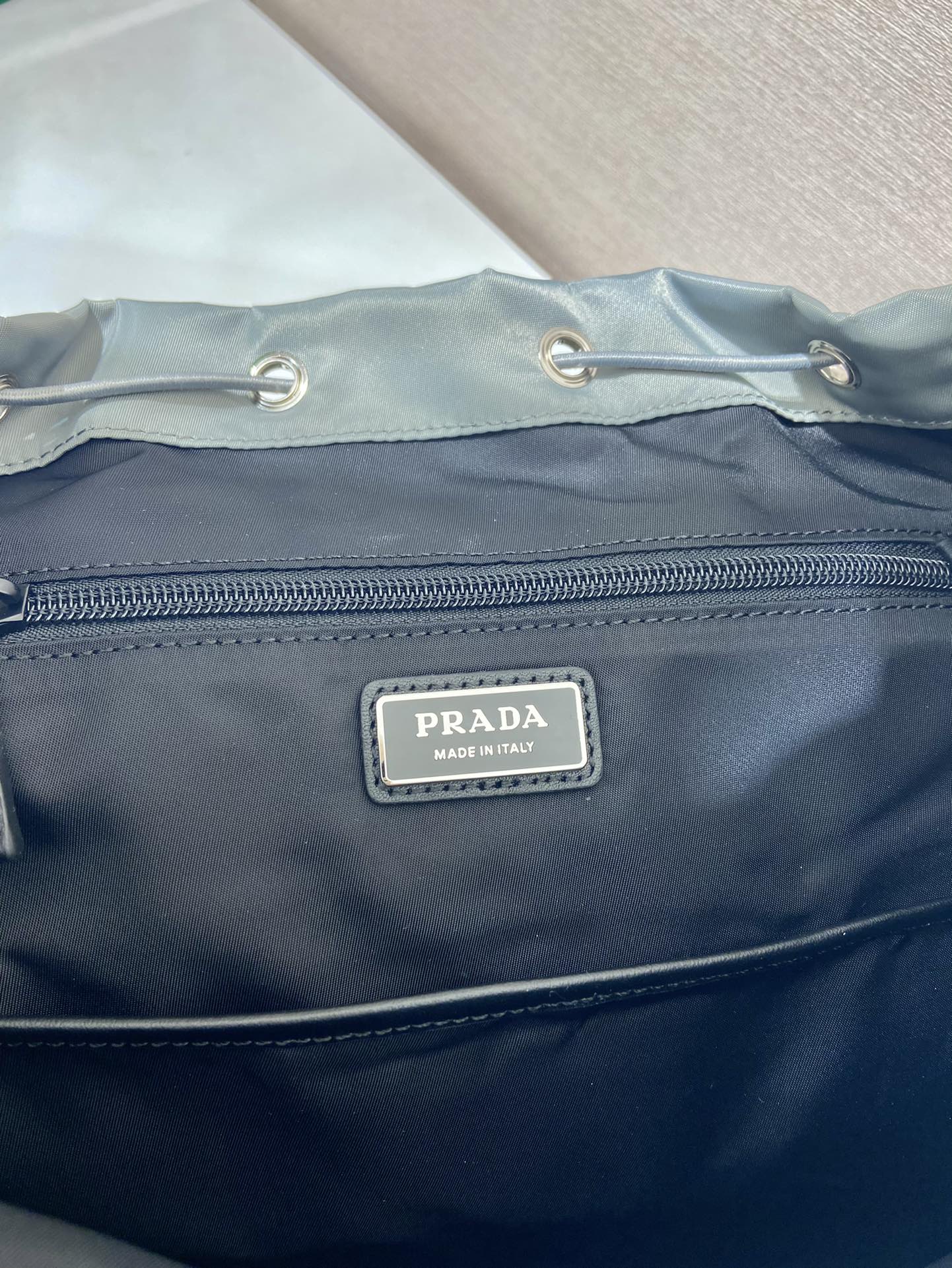 PRADA TRIANGLE LOGO BACKPACK 45 IN ASH GRAY RE-NYLON