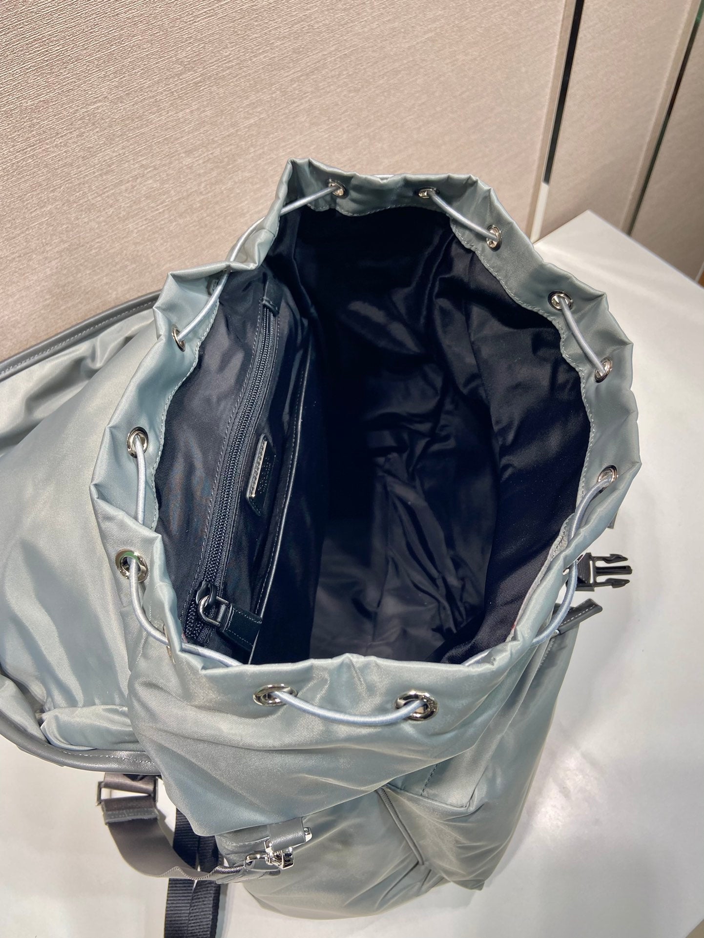 PRADA TRIANGLE LOGO BACKPACK 45 IN ASH GRAY RE-NYLON