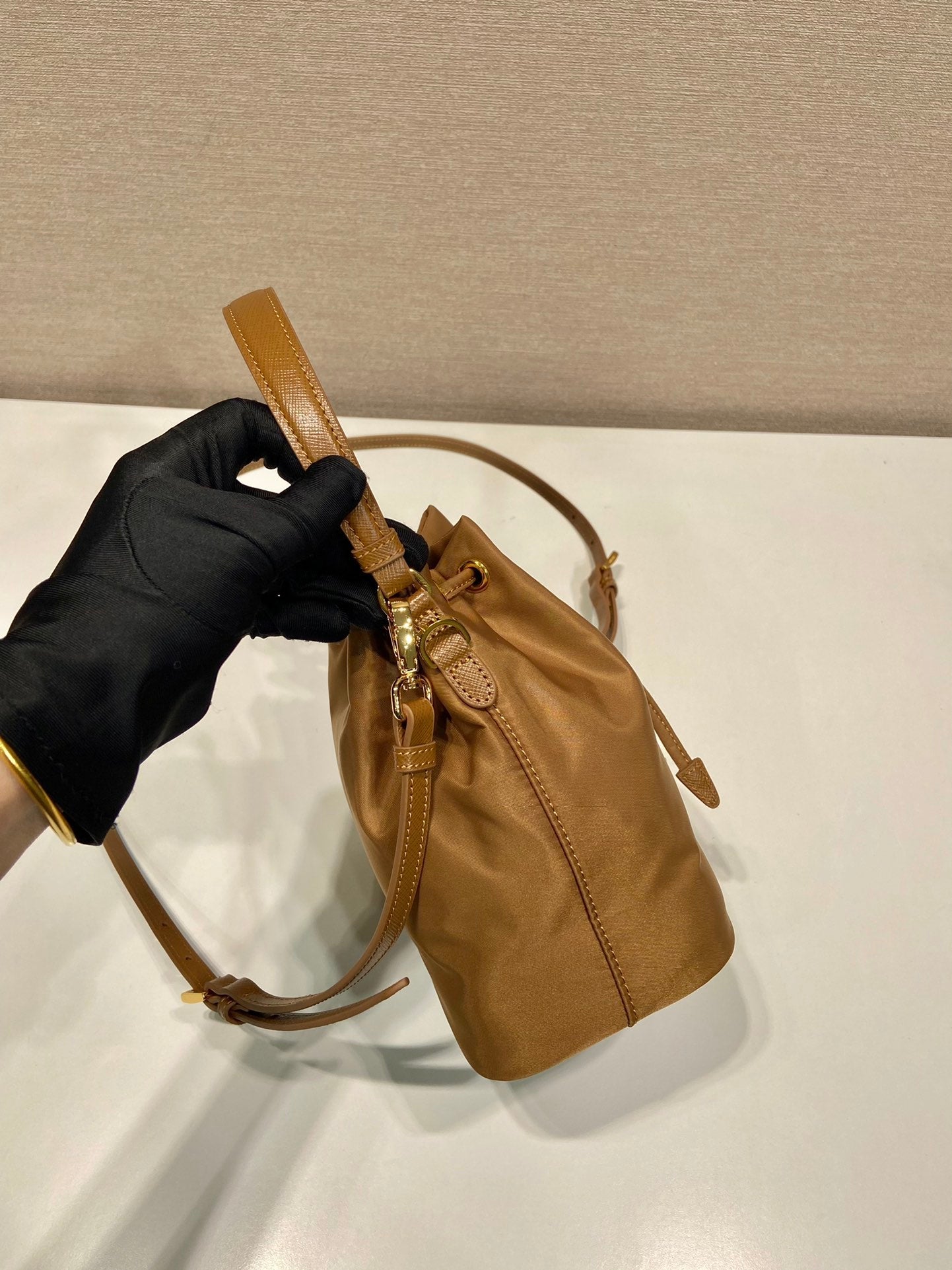 PRADA BUCKET BAG 19 IN RUSSET BROWN RE-NYLON AND CALFSKIN HANDLE