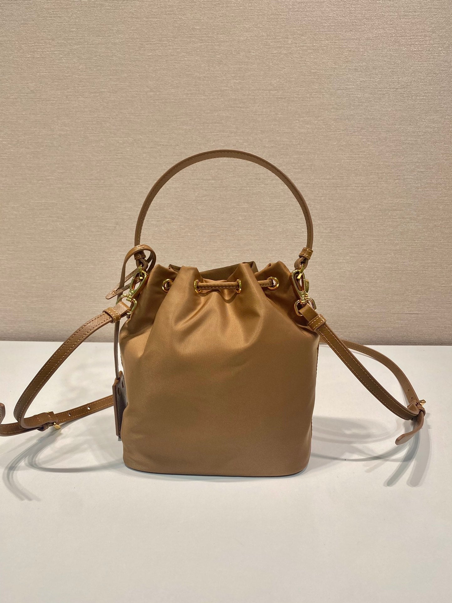 PRADA BUCKET BAG 19 IN RUSSET BROWN RE-NYLON AND CALFSKIN HANDLE