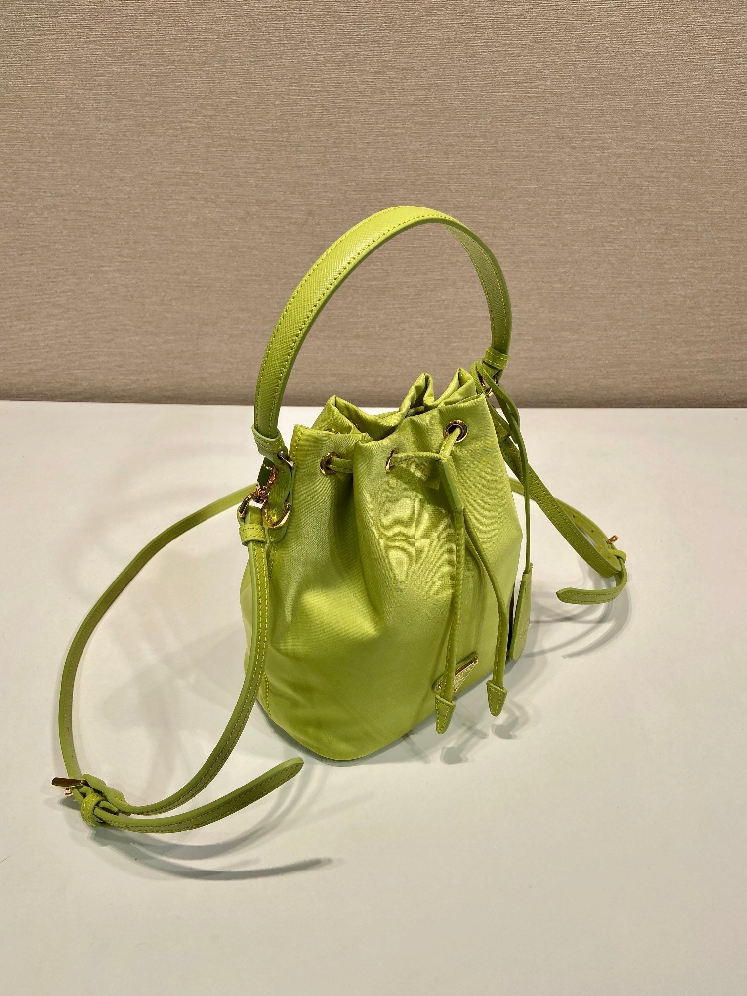 PRADA BUCKET BAG 19 IN APPLE GREEN RE-NYLON AND SAFFIANO LEATHER HANDLE