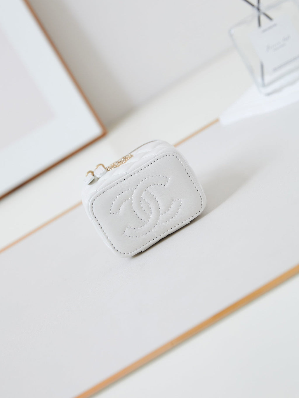 CHANEL 25S MINI VANITY BAG 11 CM IN WHITE LAMBSKIN WITH CRYSTAL-EMBELLISHED  LOGO