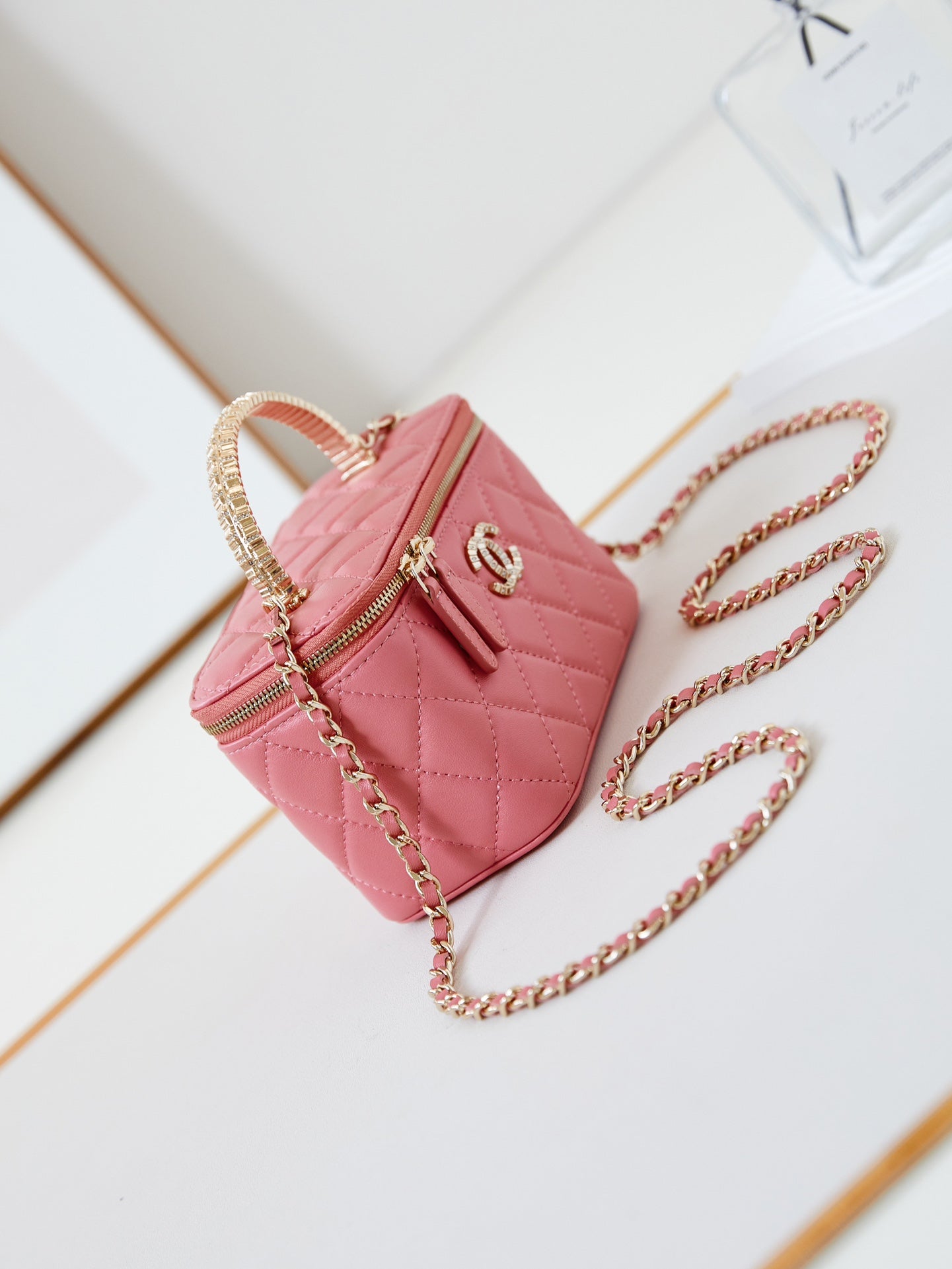 CHANEL 25S MINI VANITY BAG 16 CM IN PEACHY PINK LAMBSKIN WITH CRYSTAL-EMBELLISHED  LOGO