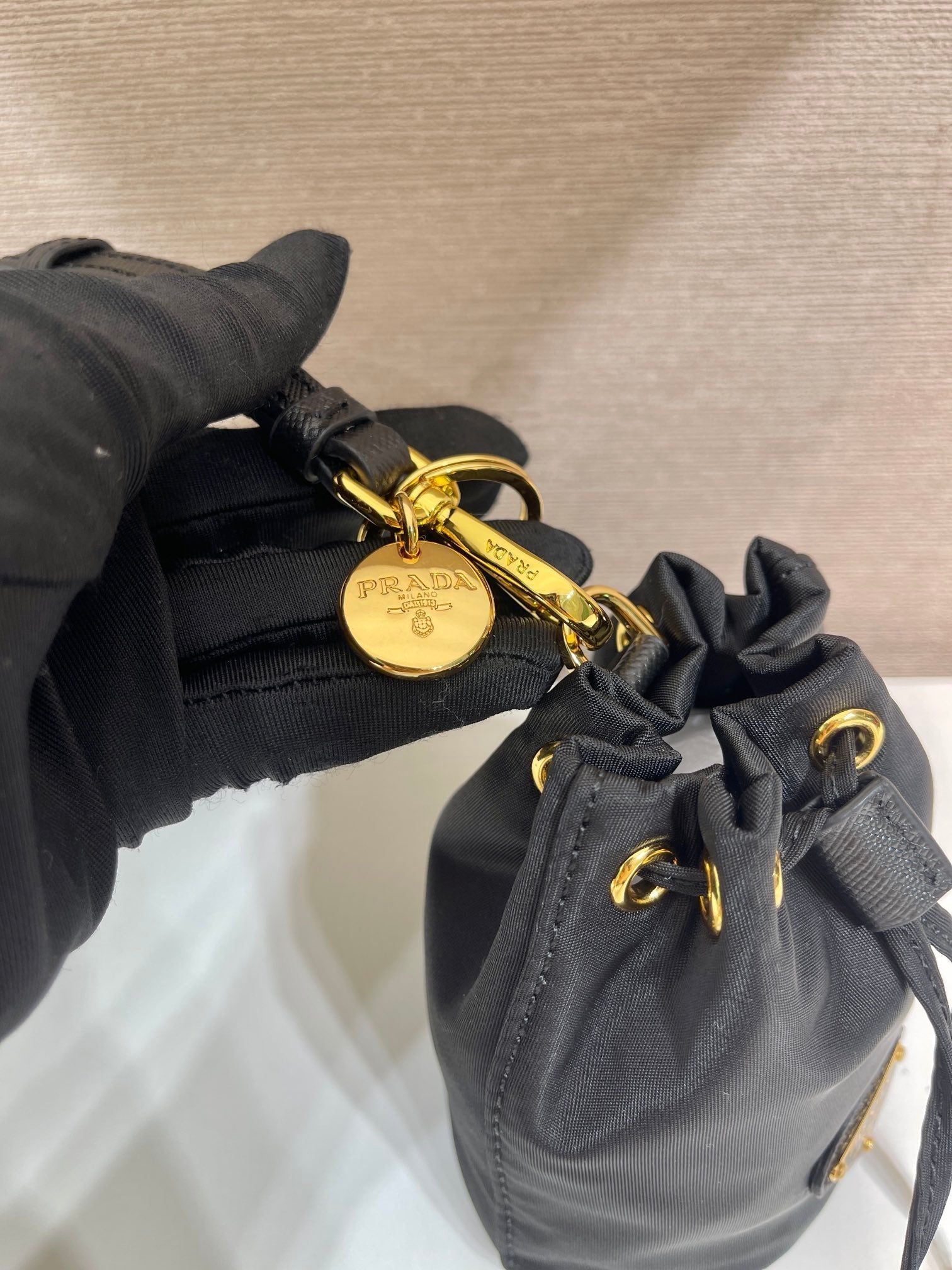 PRADA MINI BUCKET BAG 10 IN BLACK RE-NYLON AND SAFFIANO LEATHER STRAP