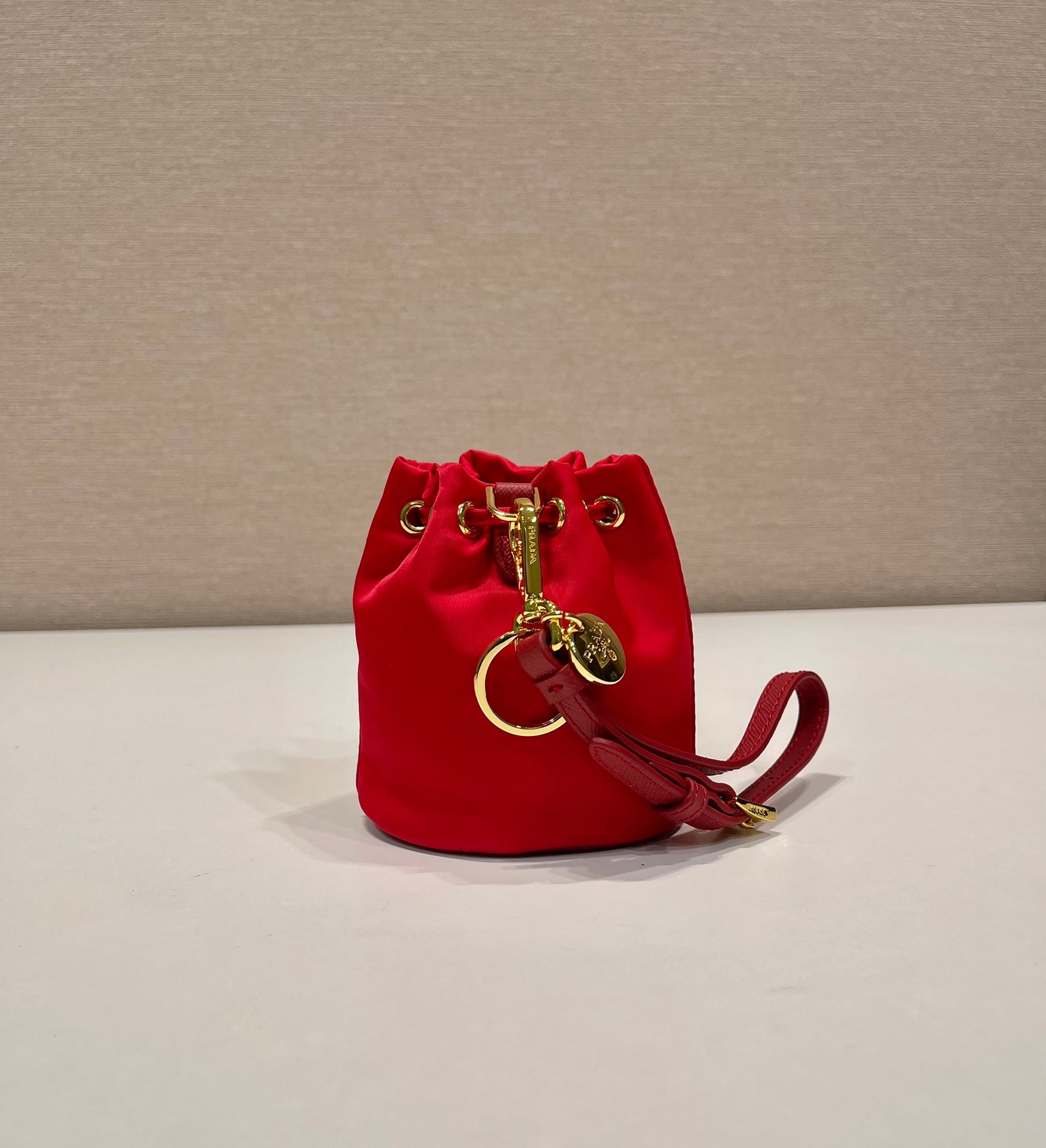 PRADA MINI BUCKET BAG 10 IN RED RE-NYLON AND SAFFIANO LEATHER STRAP