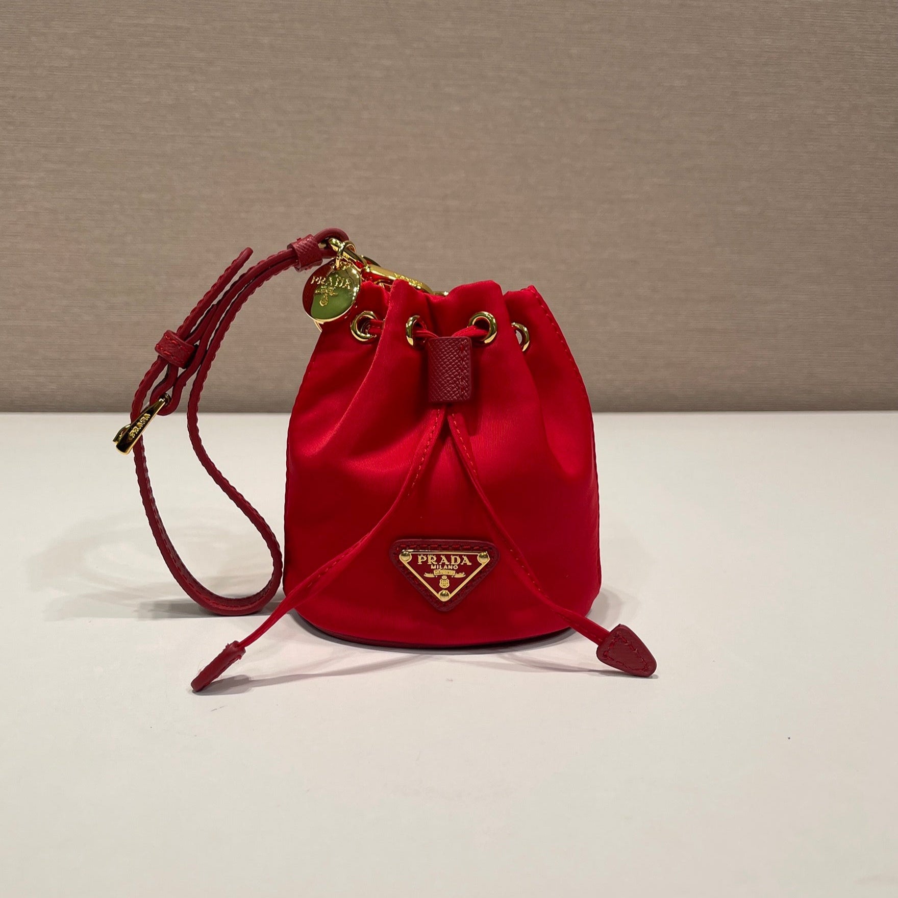 PRADA MINI BUCKET BAG 10 IN RED RE-NYLON AND SAFFIANO LEATHER STRAP