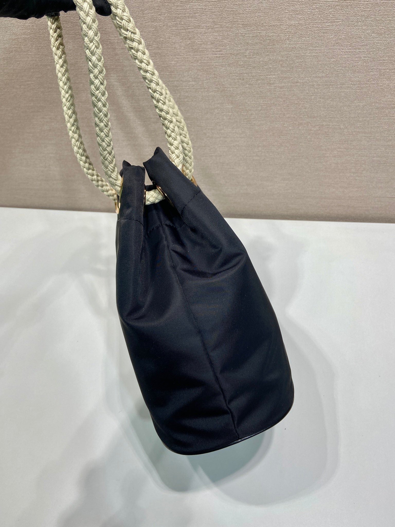 PRADA BUCKET BAG 28 IN BLACK RE-NYLON GOLD LOGO