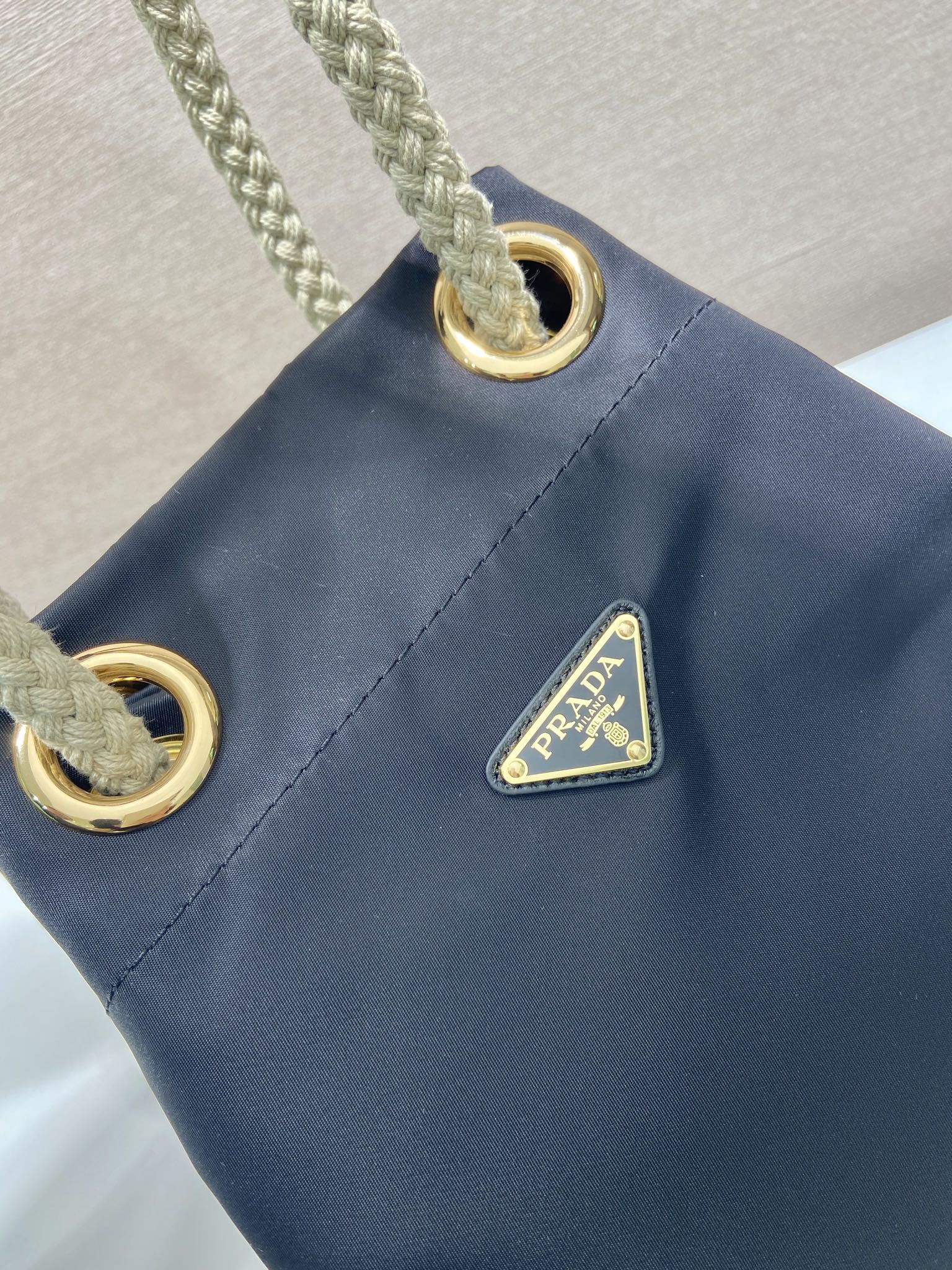 PRADA BUCKET BAG 28 IN BLACK RE-NYLON GOLD LOGO