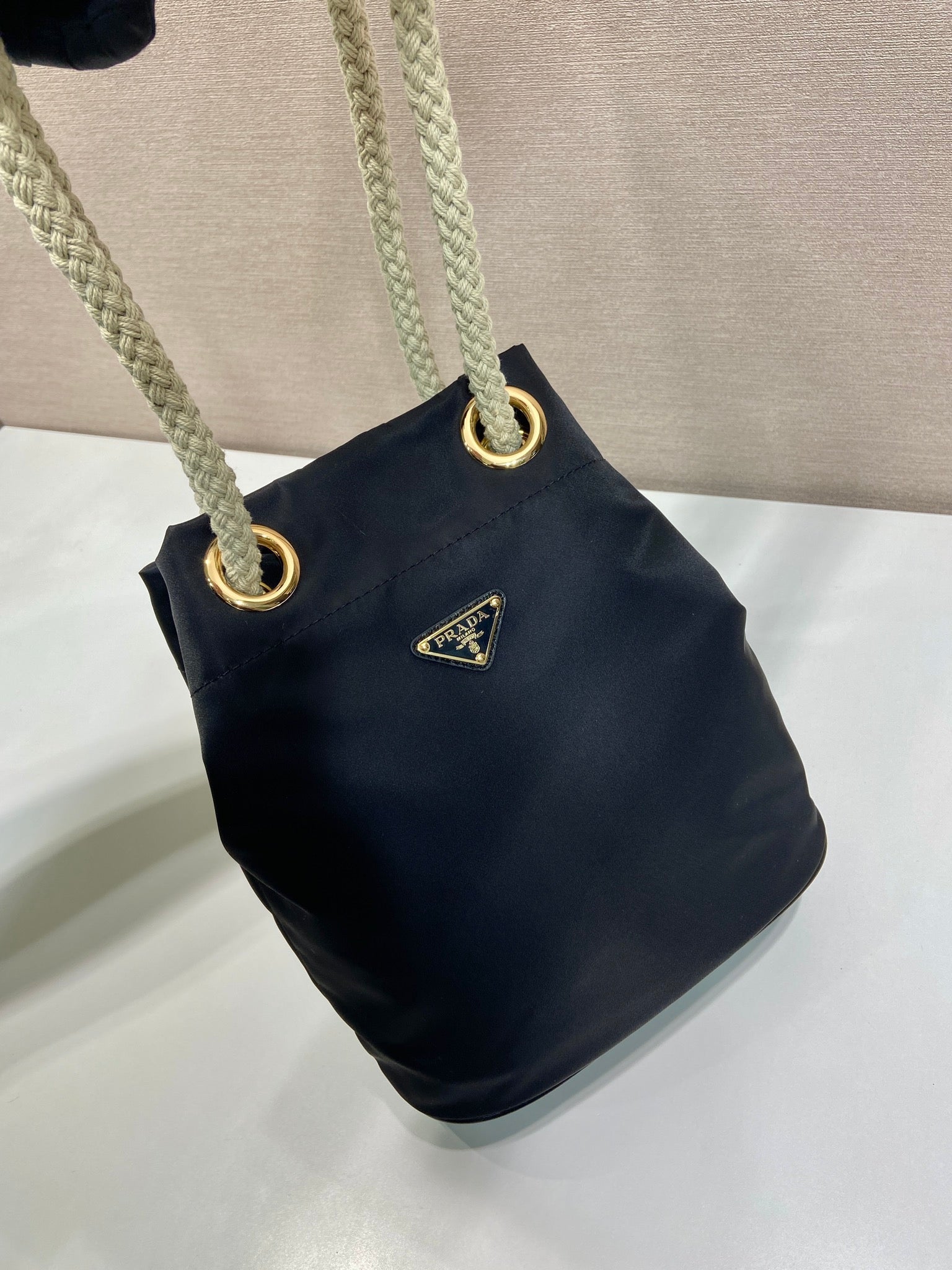 PRADA BUCKET BAG 28 IN BLACK RE-NYLON GOLD LOGO