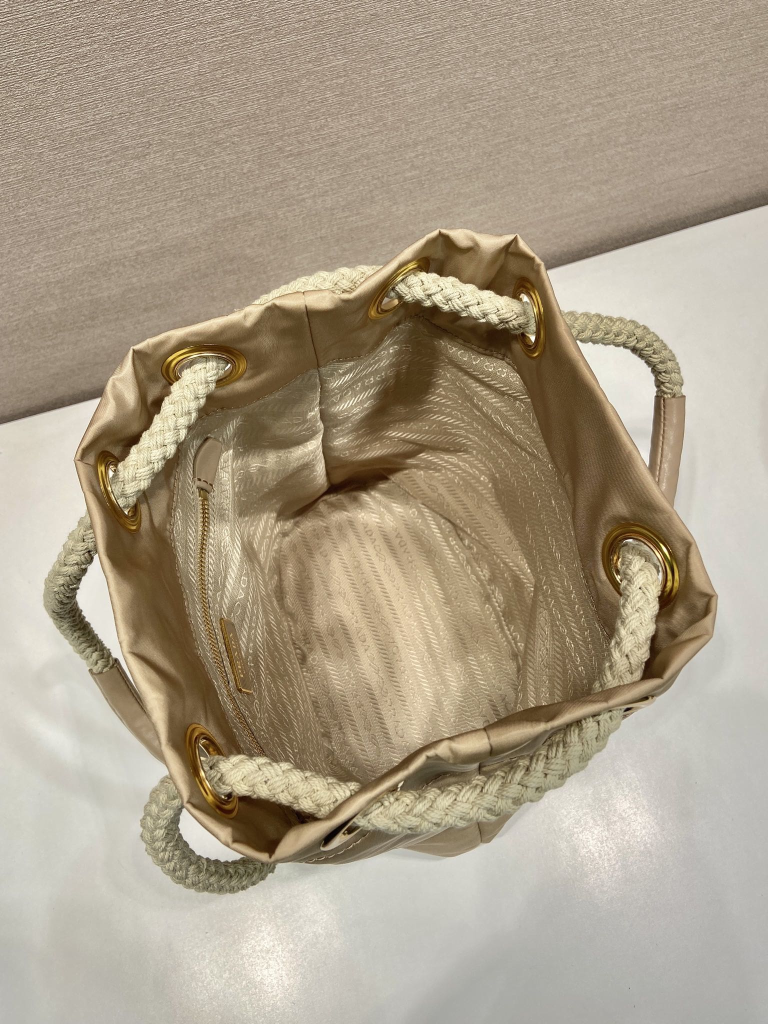 PRADA BUCKET BAG 28 IN BEIGE RE-NYLON GOLD LOGO