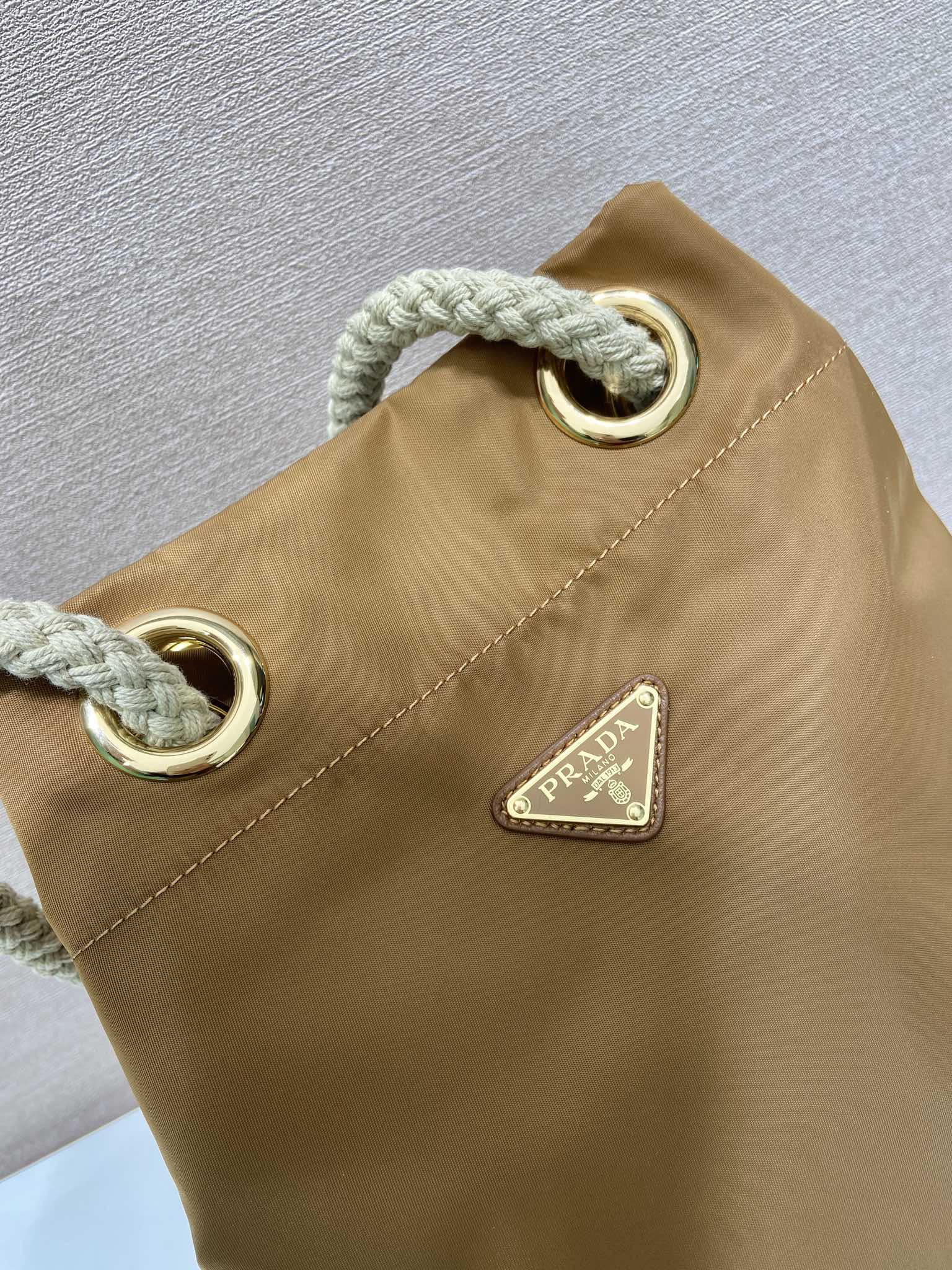PRADA BUCKET BAG 28 IN SEPIA BROWN RE-NYLON GOLD LOGO