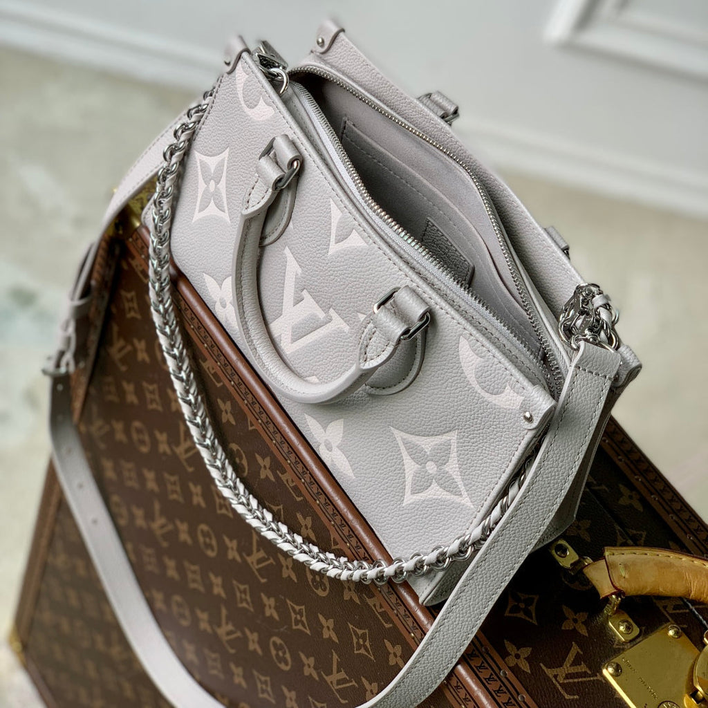 LOUIS VUITTON ONTHEGO EAST WEST BAG 25 IN BICOLOR MONOGRAM EMPREINTE LEATHER