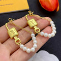 18K Louis Vuitton Pearl Lock Gold Earrings