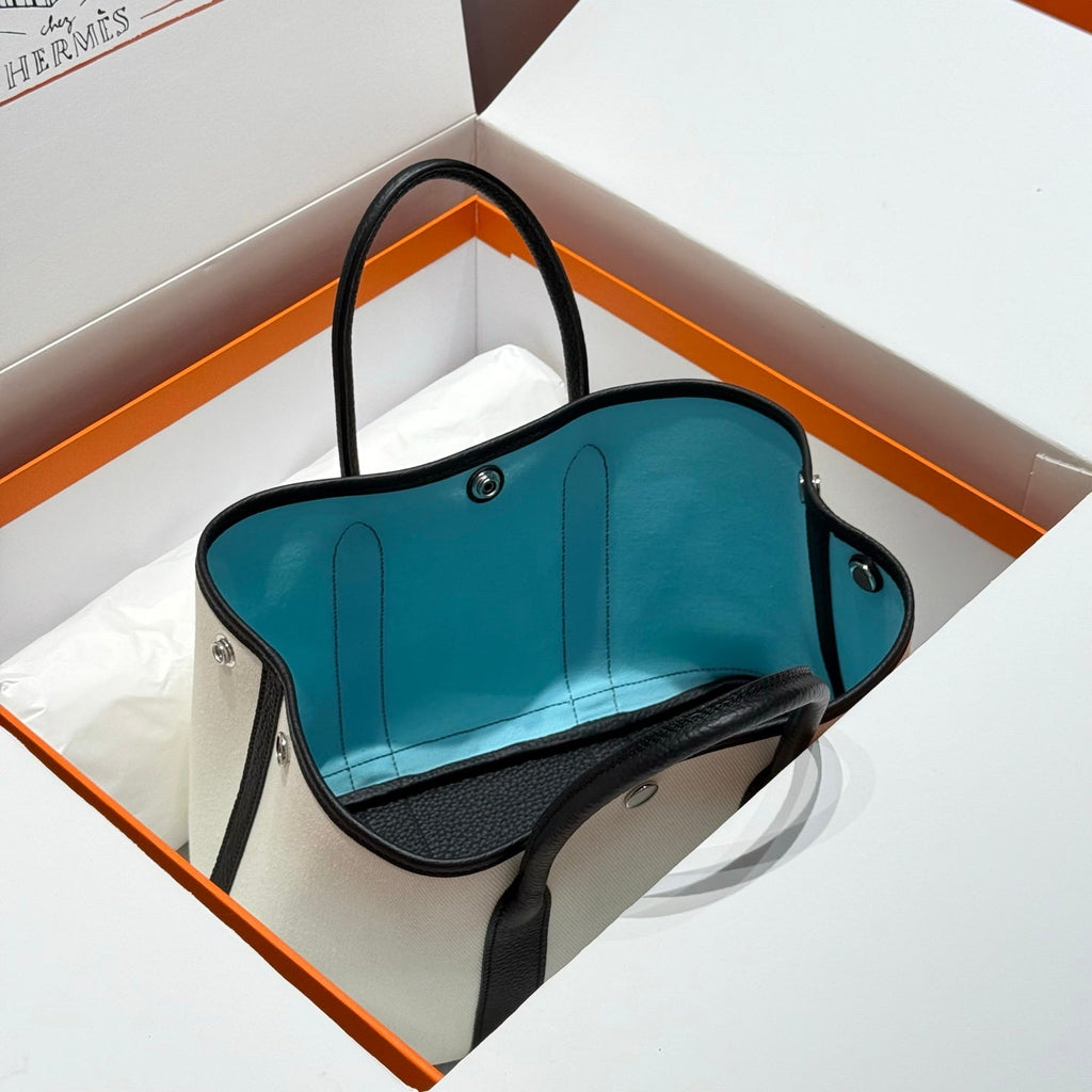 HERMES GARDEN PARTY 30CM IN WHITE TOILETS COTTON CANVAS AND BLACK CALFSKIN SKY BLUE CANVAS ON SIDE OTHER