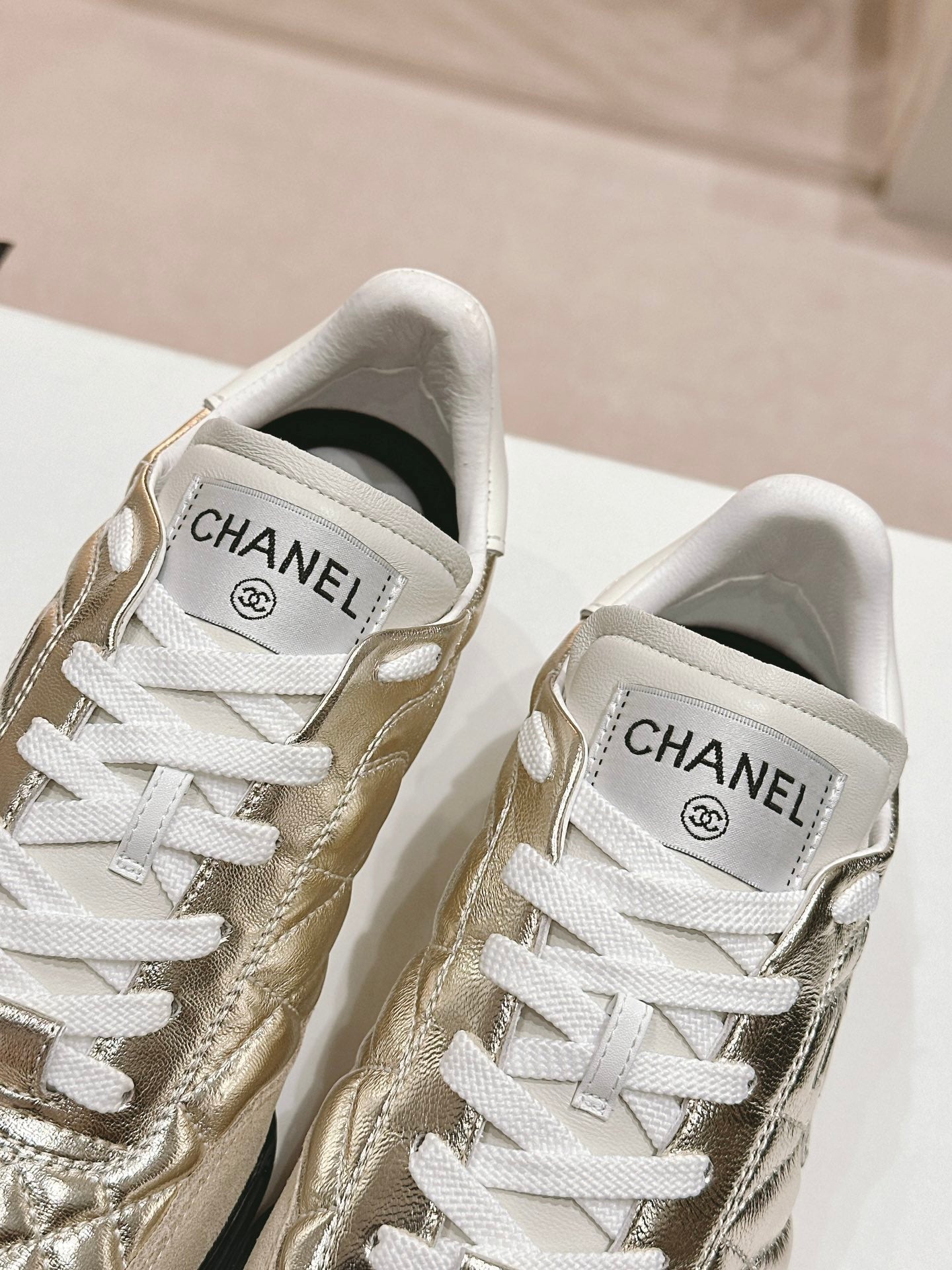 CHANEL SNEAKERS IN GLOSSY GOLDEN LAMBSKIN