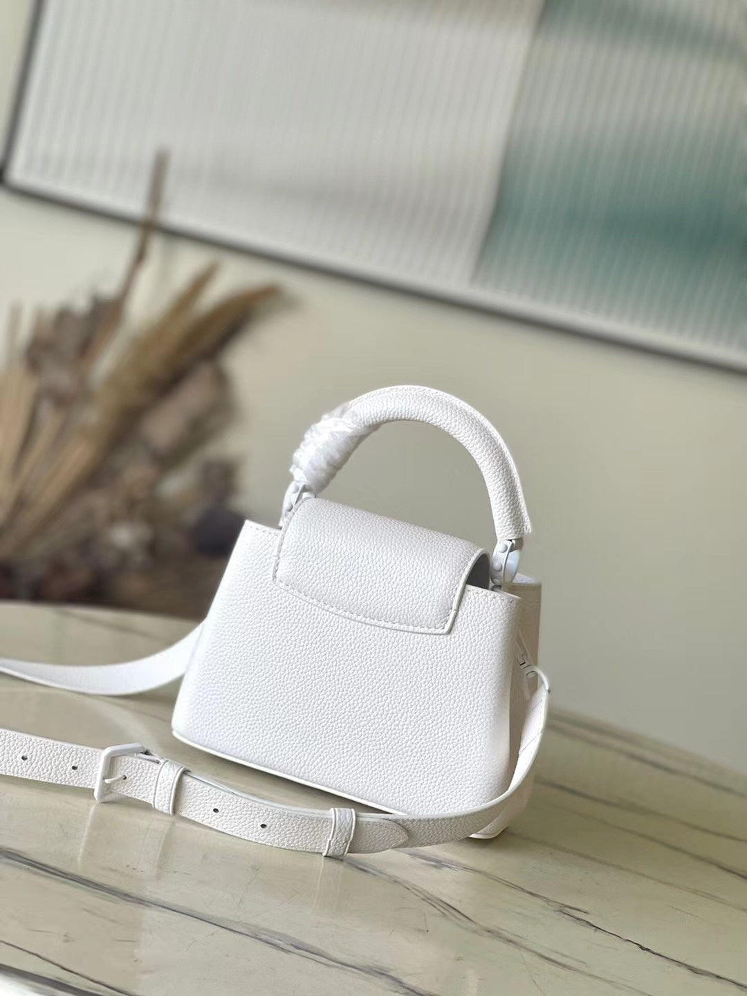 LOUIS VUITTON CAPUCINES EAST-WEST MINI 21 IN WHITE TAURILLON