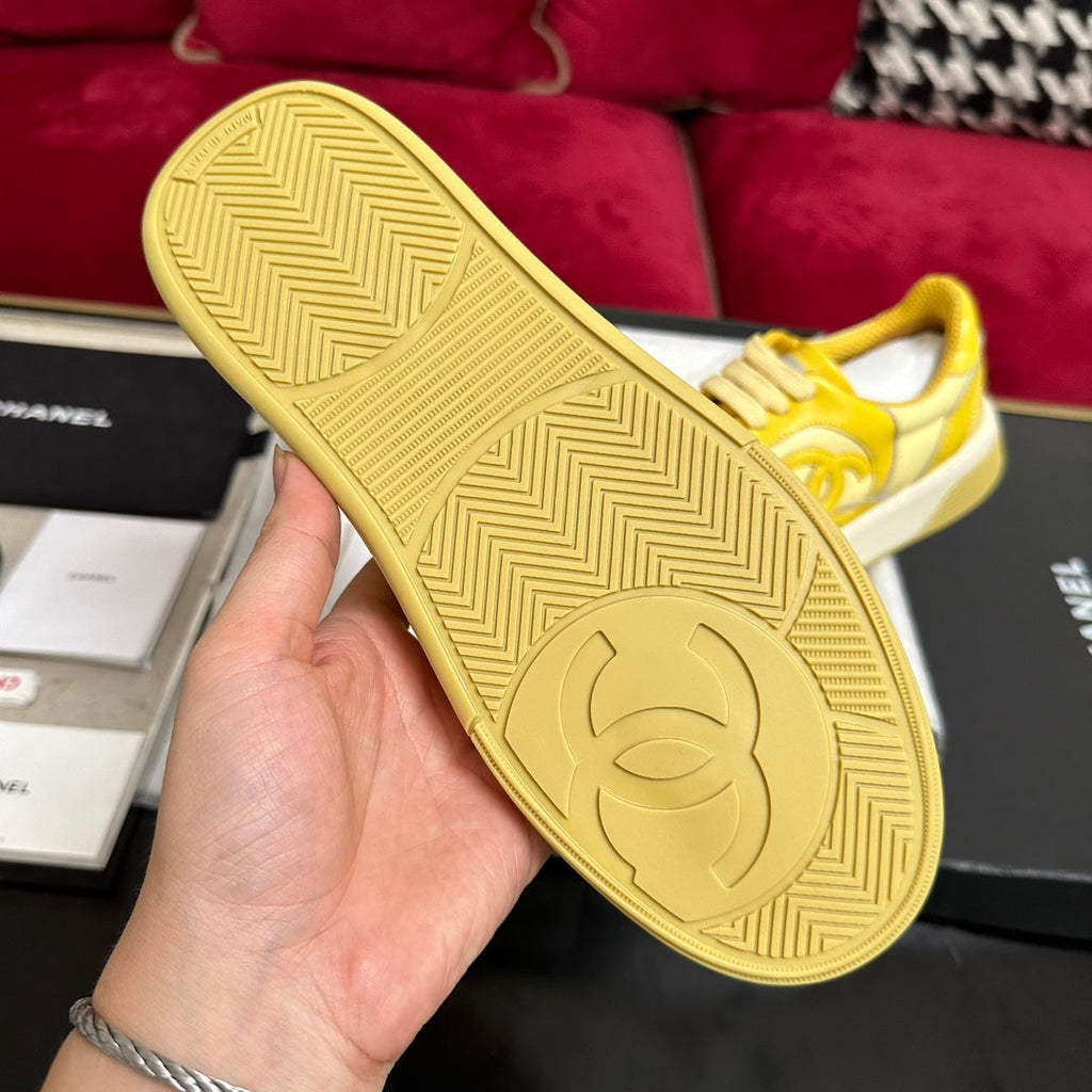 CHANEL TRAINERS IN BRIGHT YELLOW SHINY CALFSKIN