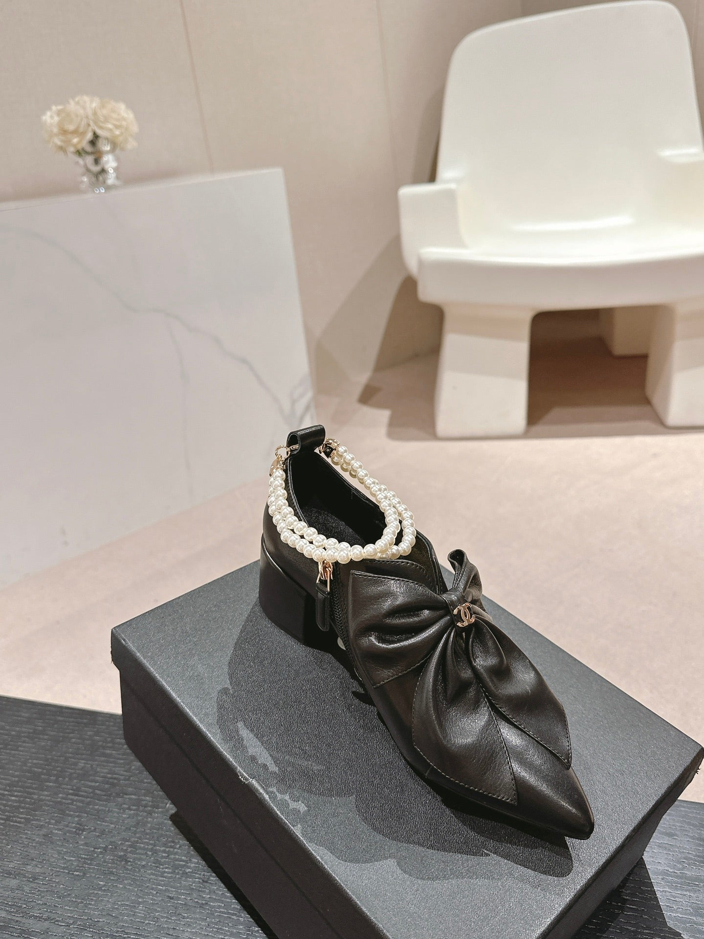 CHANEL SHORT BOOTS IN BLACK SHEEPSKIN WITH BOW