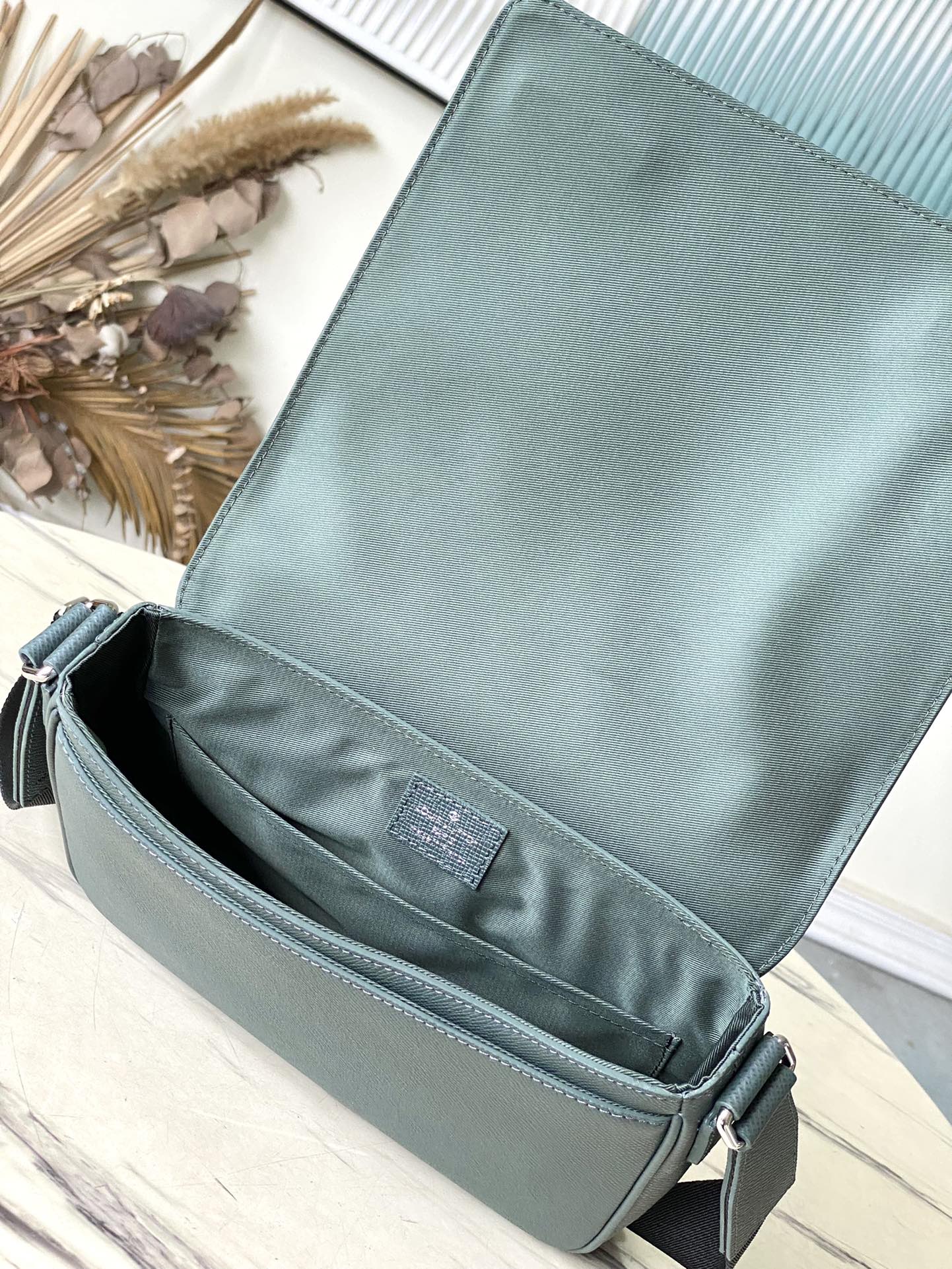 LOUIS VUITTON DISTRICT PM 26 IN CELESTE GREEN CALFSKIN