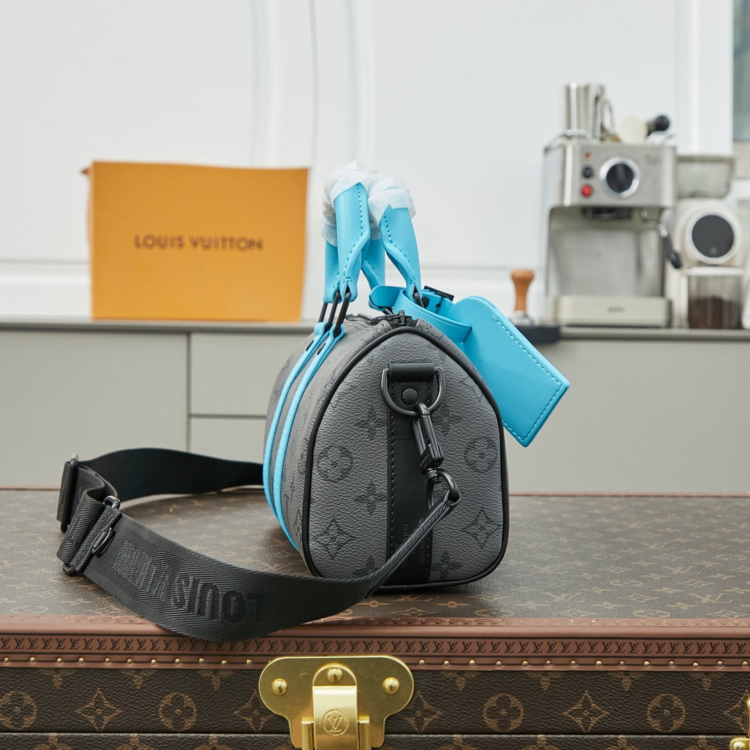 LOUIS VUITTON KEEPALL BANDOULIÈRE 25 IN GUN METAL MONOGRAM ECLIPSE CANVAS MIX TURQUOISE CALFSKIN