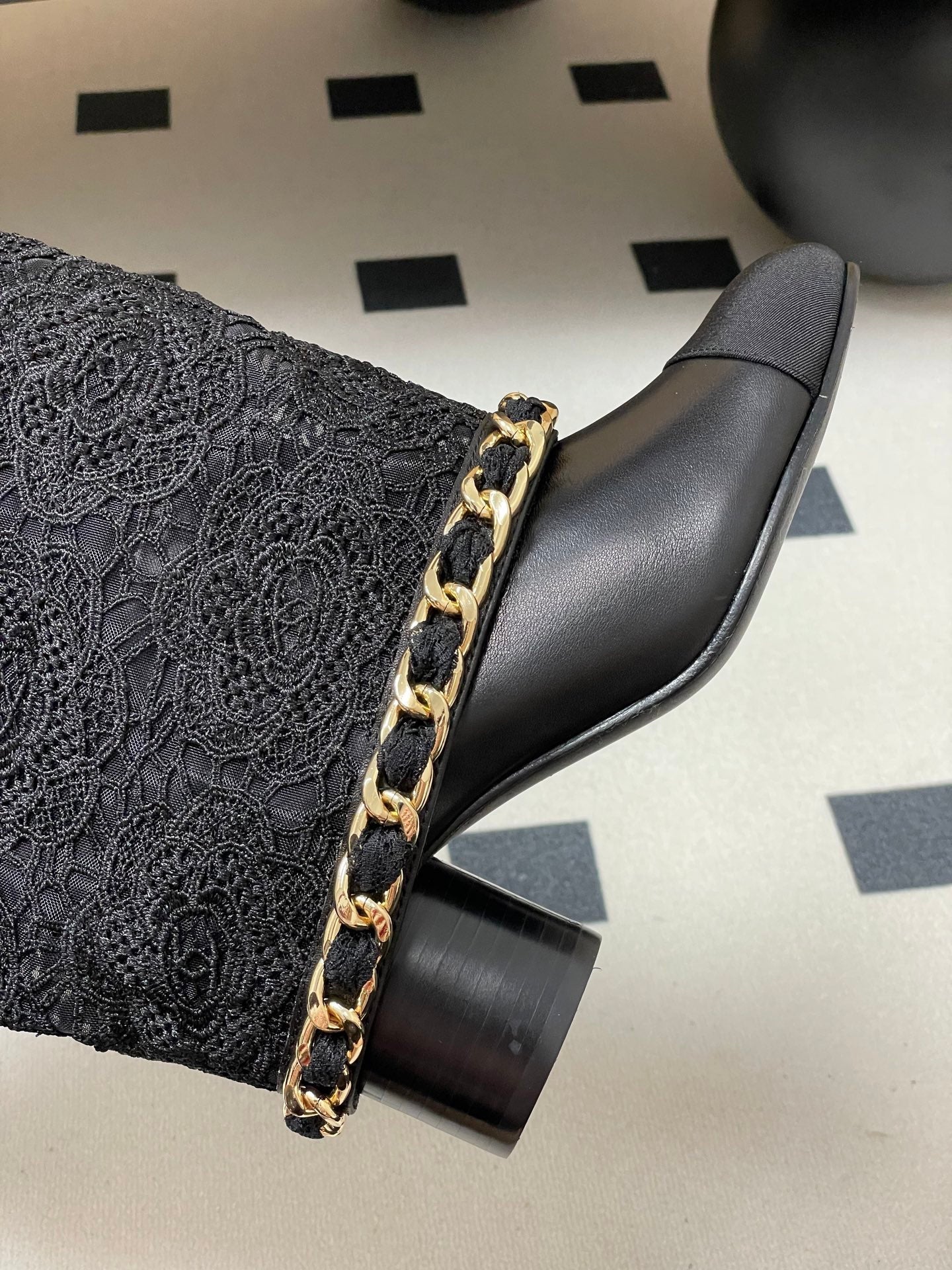 CHANEL FLORAL BOOTS 60MM IN BLACK CALFSKIN WITH GOLD CHAIN
