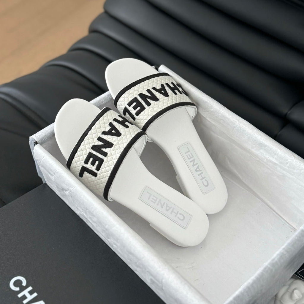 CHANEL Woven Embroidered Letter Slippers White Black
