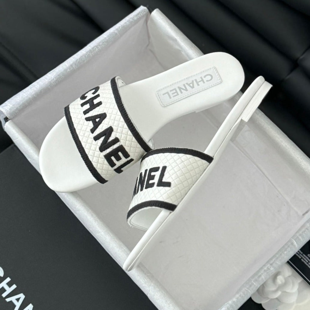 CHANEL Woven Embroidered Letter Slippers White Black