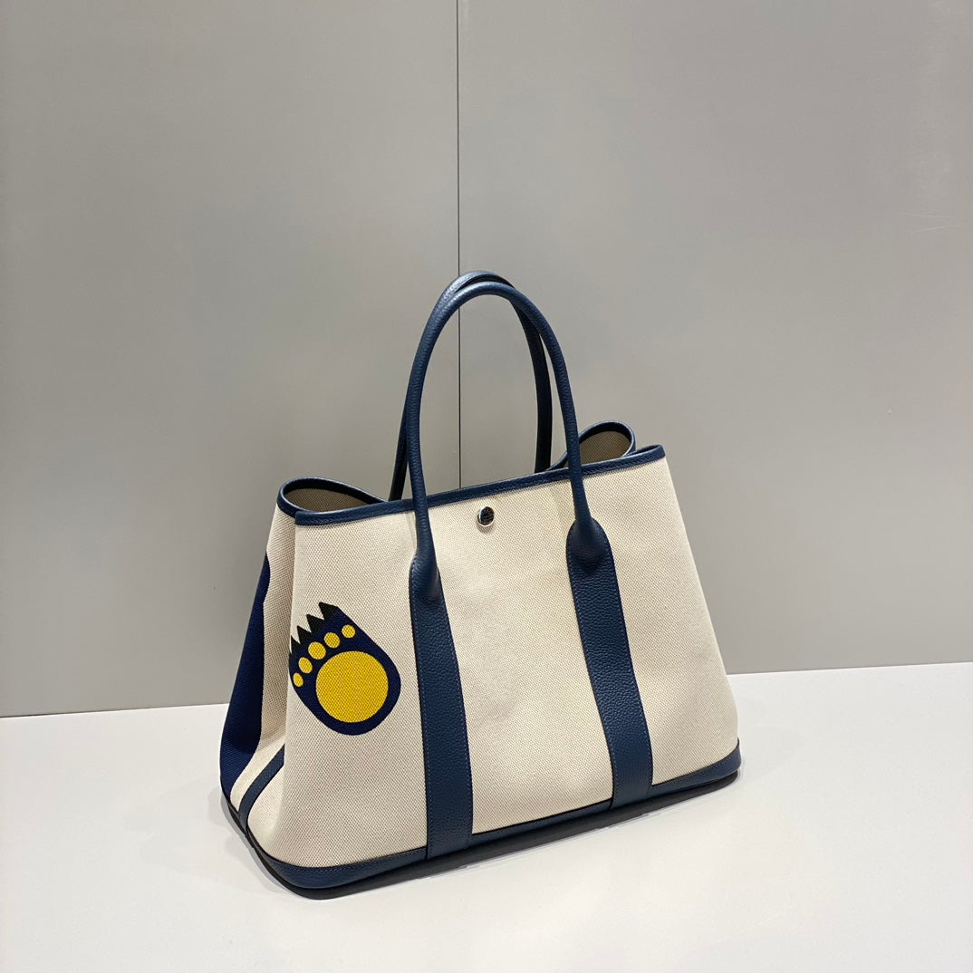 HERMES GARDEN PARTY 36 IN NAVY CREAM TOILE H CANVAS BLUE MARINE CALFSKIN ABSTRACT BEAR FACE PRINT