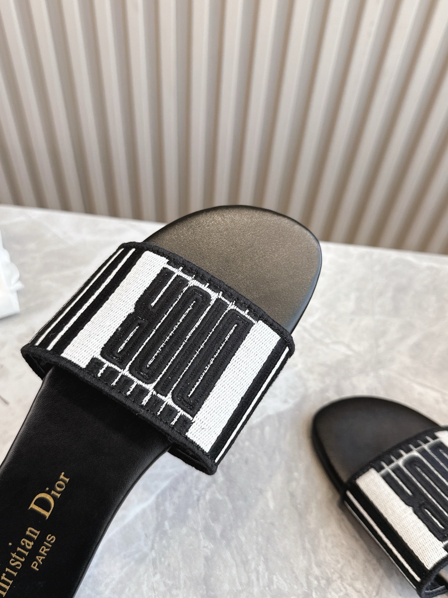 DIOR FLAT SLIDES 25S IN BLACK CALFSKIN AND FABRIC BRAND NAME EMBROIDERY