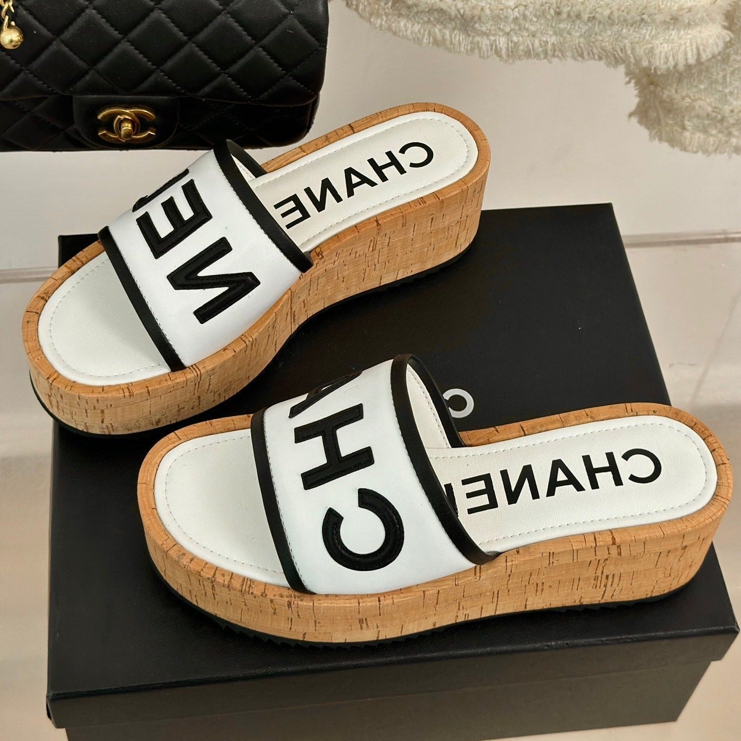 CHANEL THICK SOLE LETTER SLIPPERS IN WHITE SHEEPSKIN