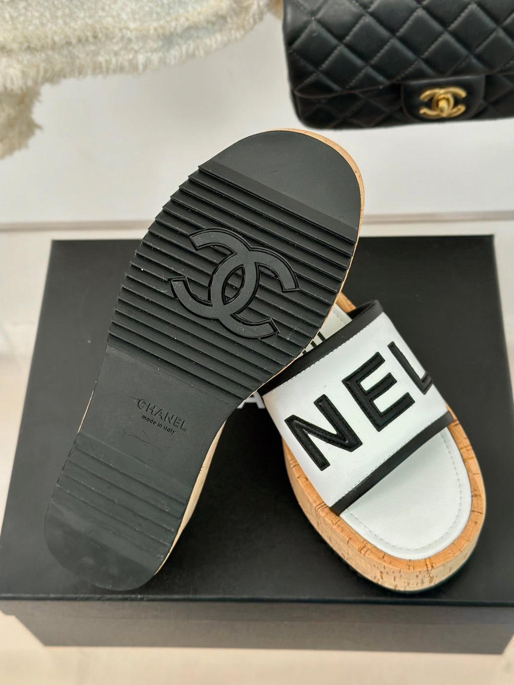 CHANEL THICK SOLE LETTER SLIPPERS IN WHITE SHEEPSKIN
