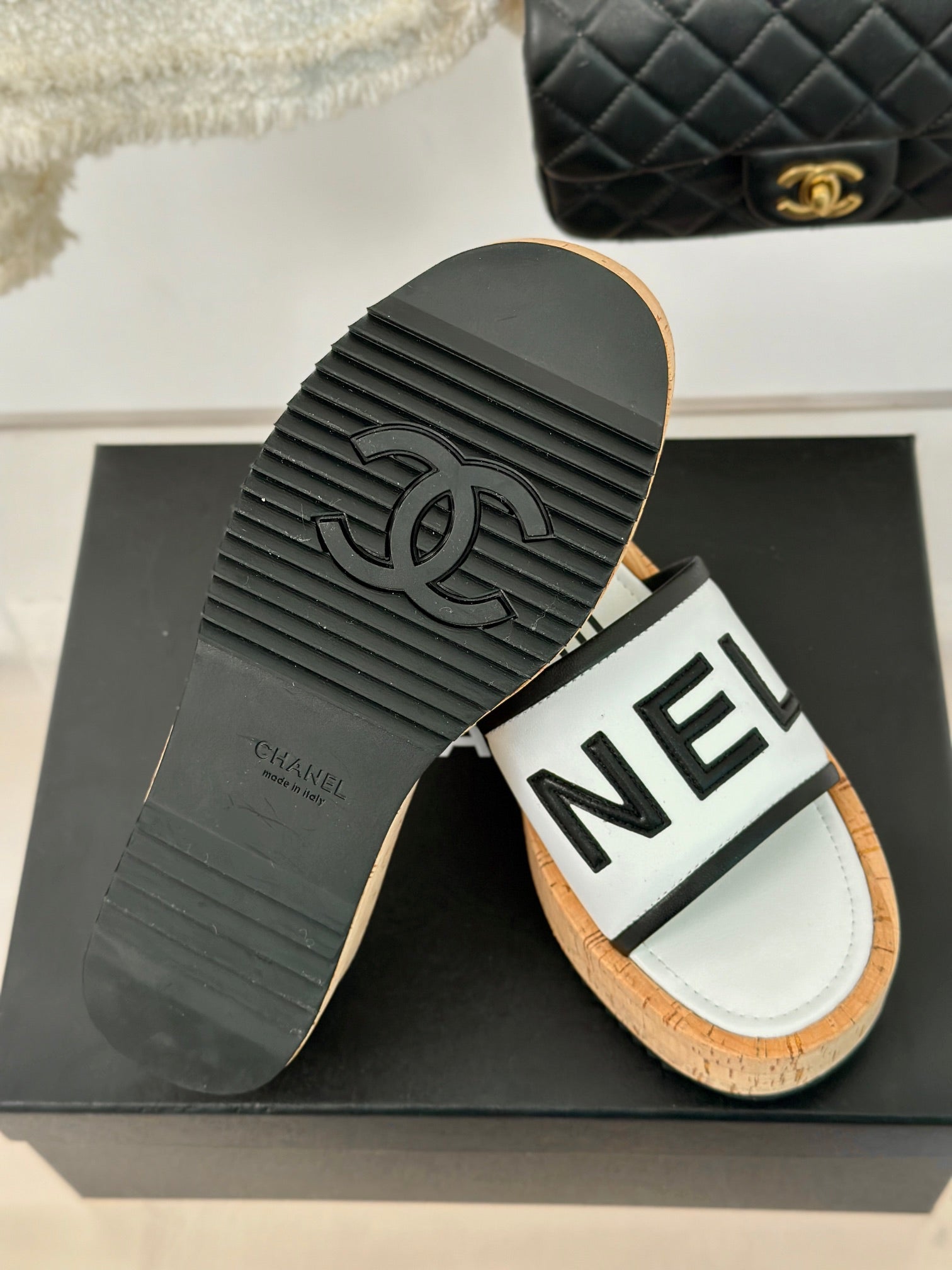 CHANEL THICK SOLE LETTER SLIPPERS IN WHITE SHEEPSKIN