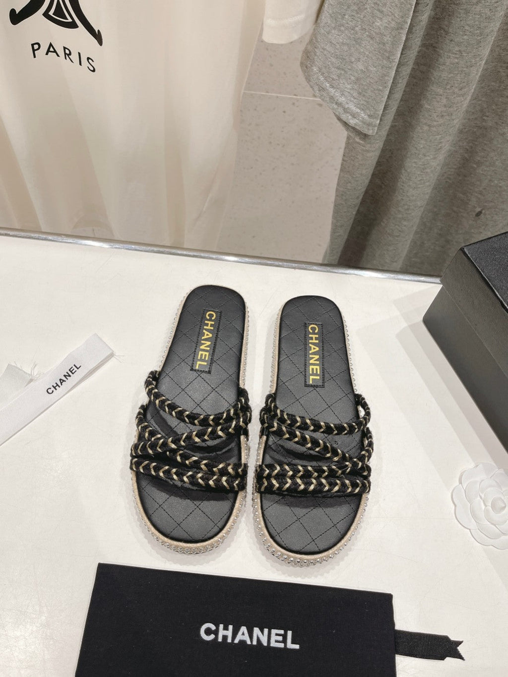 CHANEL WOVEN STRAP SLIPPERS IN BLACK LAMBSKIN